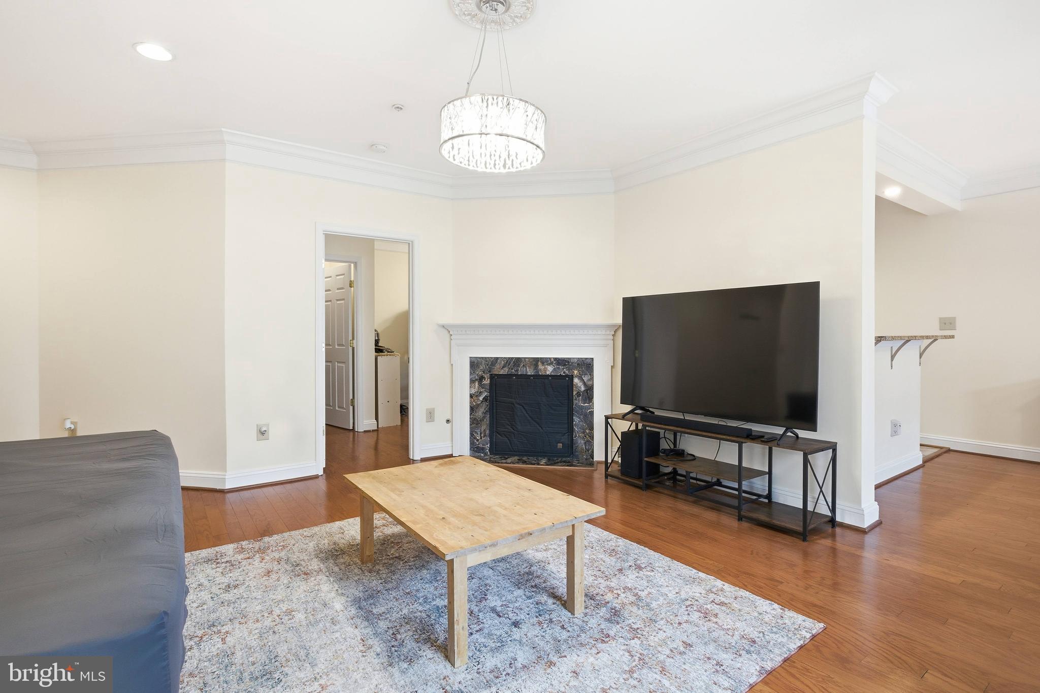 11302 Westbrook Mill Lane, Unit 204 Fairfax, VA 22030 - Photo 21 of 30 a living room with furniture and a flat screen tv