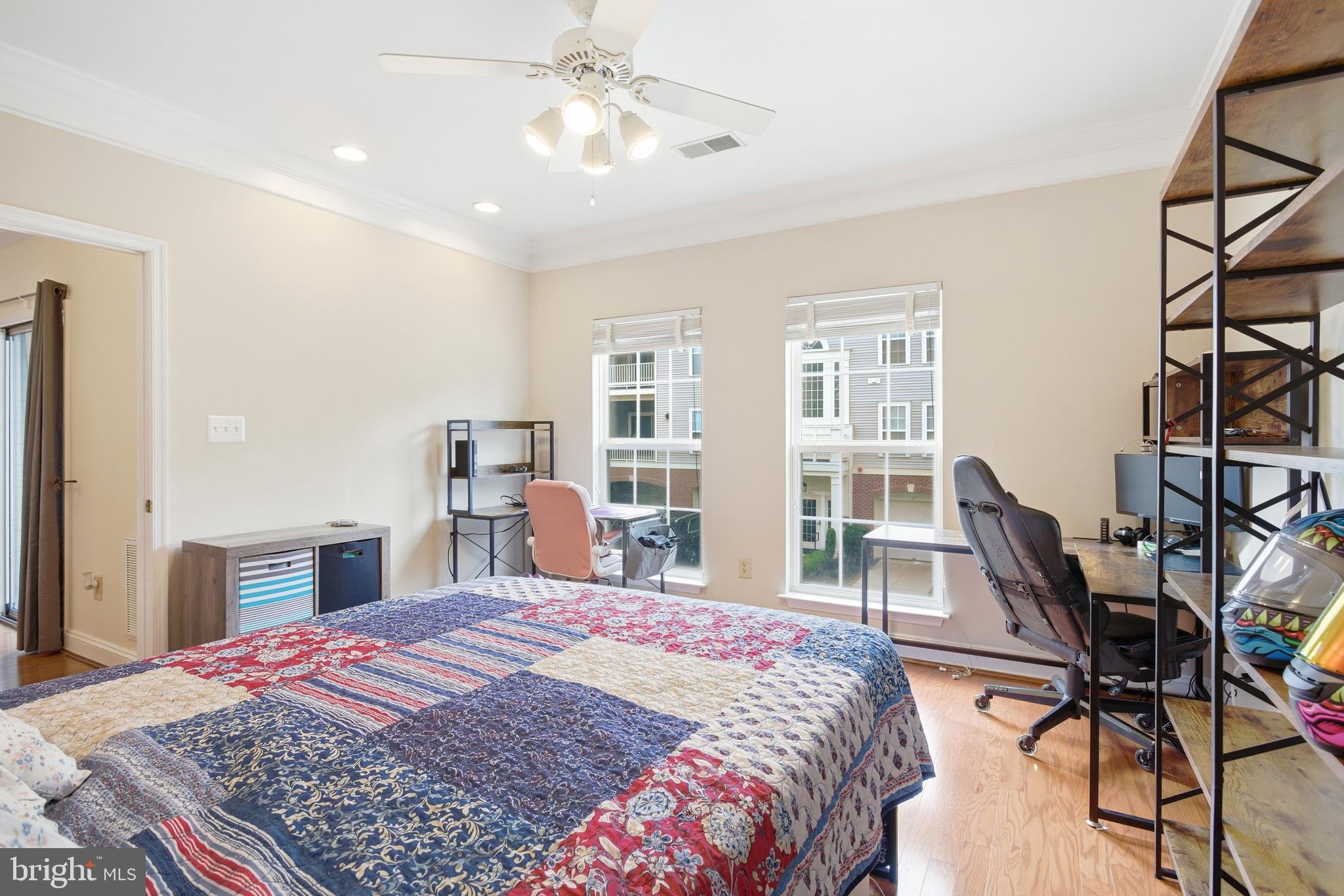 11302 Westbrook Mill Lane, Unit 204 Fairfax, VA 22030 - Photo 25 of 30 a bedroom with a large bed and a chandelier