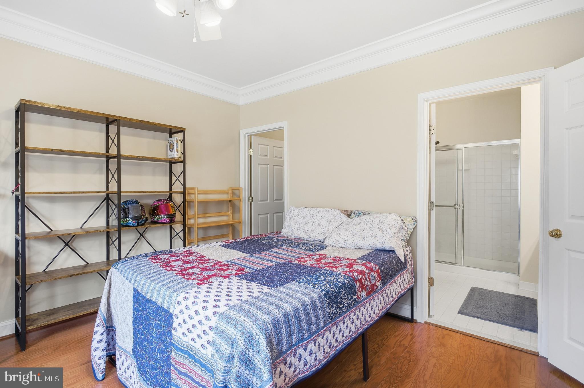11302 Westbrook Mill Lane, Unit 204 Fairfax, VA 22030 - Photo 26 of 30 a bedroom with a bed and glass walk in closet
