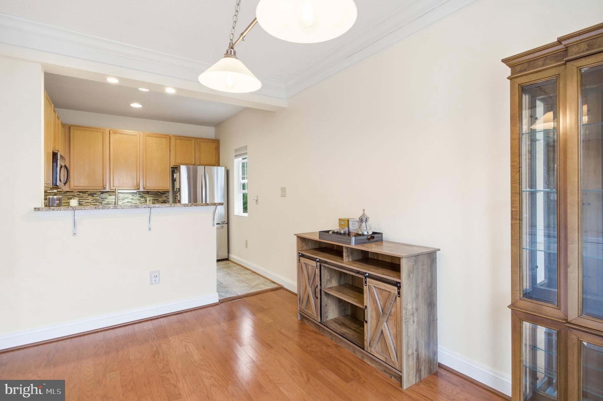 11302 Westbrook Mill Lane, Unit 204 Fairfax, VA 22030 - Photo 8 of 30 a kitchen with stainless steel appliances a stove and a refrigerator