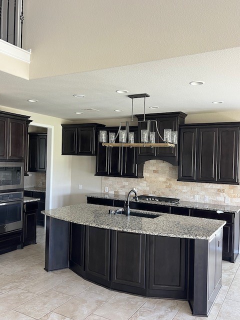 2730 Cutter Court Manvel, TX 77578 - Photo 13 of 39 a kitchen with granite countertop a sink and cabinets