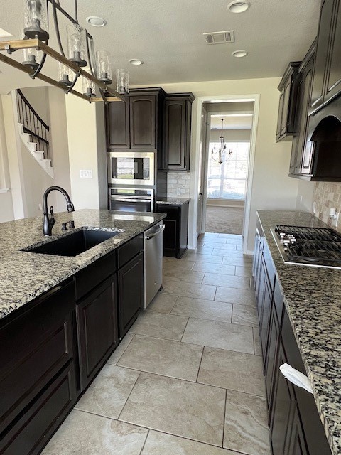 2730 Cutter Court Manvel, TX 77578 - Photo 15 of 39 a kitchen with stainless steel appliances granite countertop a sink and cabinets