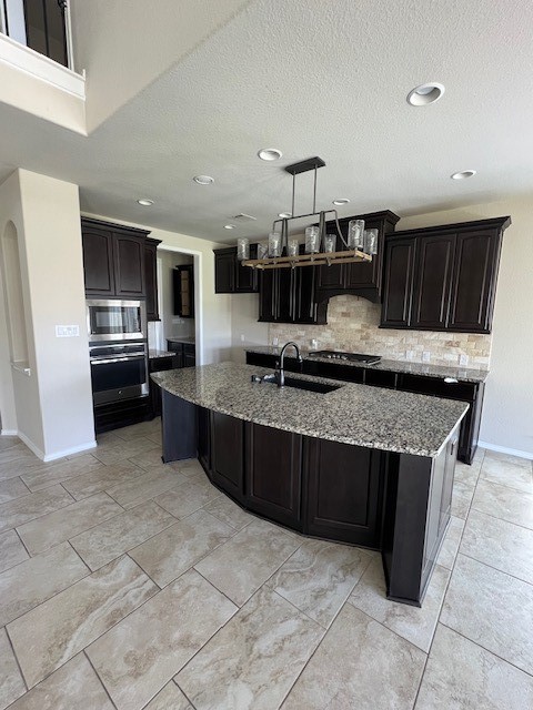 2730 Cutter Court Manvel, TX 77578 - Photo 17 of 39 a kitchen with stainless steel appliances granite countertop a stove and a sink