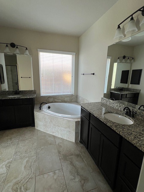 2730 Cutter Court Manvel, TX 77578 - Photo 26 of 39 a bathroom with a granite countertop bathtub sink vanity and mirror