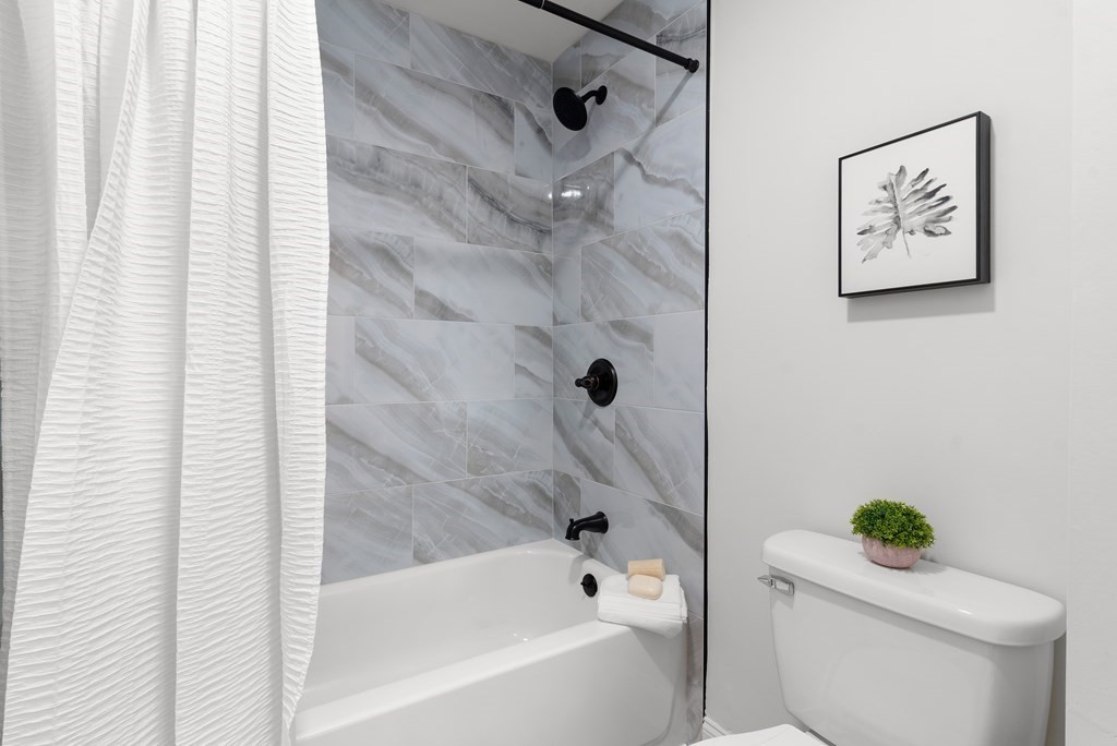 65 Glen Road, Unit H2 Brookline, MA 02445 - Photo 21 of 39 a bath tub sitting next to a white toilet and a shower curtain