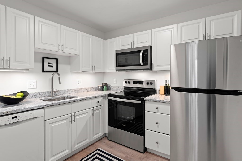 65 Glen Road, Unit H2 Brookline, MA 02445 - Photo 10 of 39 a kitchen with cabinets stainless steel appliances and a counter space