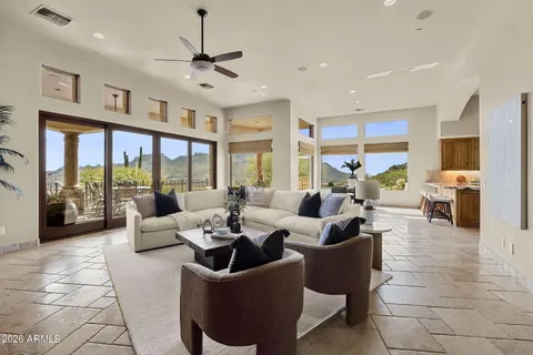 a dining room with furniture a chandelier and wooden floor