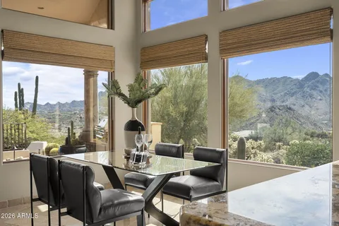 a kitchen with kitchen island granite countertop a stove and white cabinets