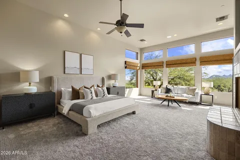 a dining room with furniture and a large window
