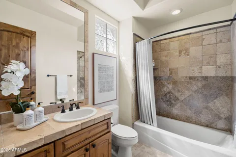 an empty room with fan and windows