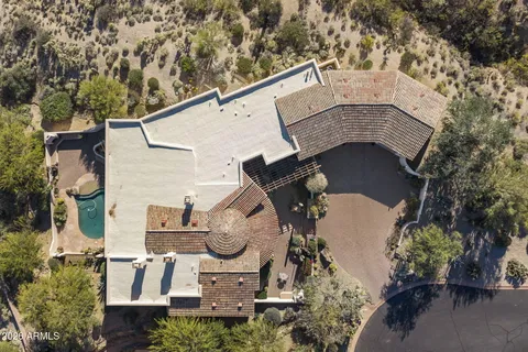 a aerial view of a house with swimming pool and a yard