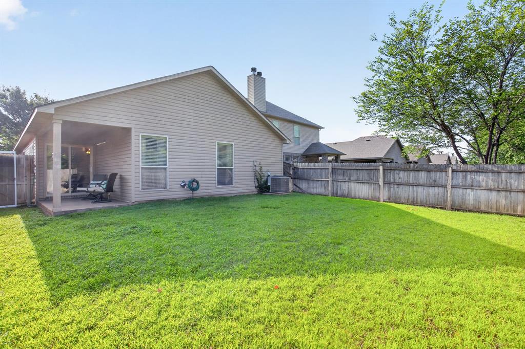 5069 Britton Ridge Lane Fort Worth, TX 76179 - Photo 27 of 32 Backyard is spacious and lined by mature trees.
