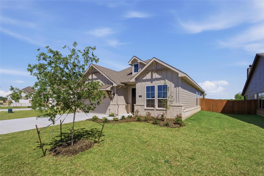 1225 Sabine River Lane Springtown, TX 76082 - Photo 2 of 25 Craftsman inspired home with board and batten siding, driveway, a garage, and brick siding