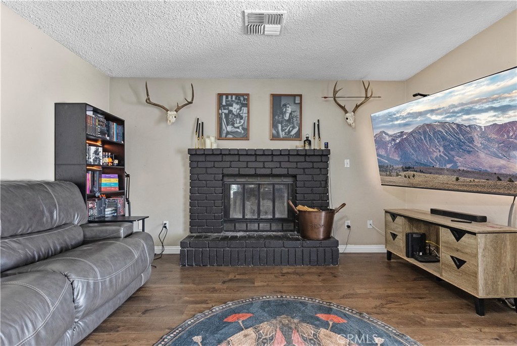 21921 Fig Court Tehachapi, CA 93561 - Photo 12 of 44 a living room with furniture and a fireplace