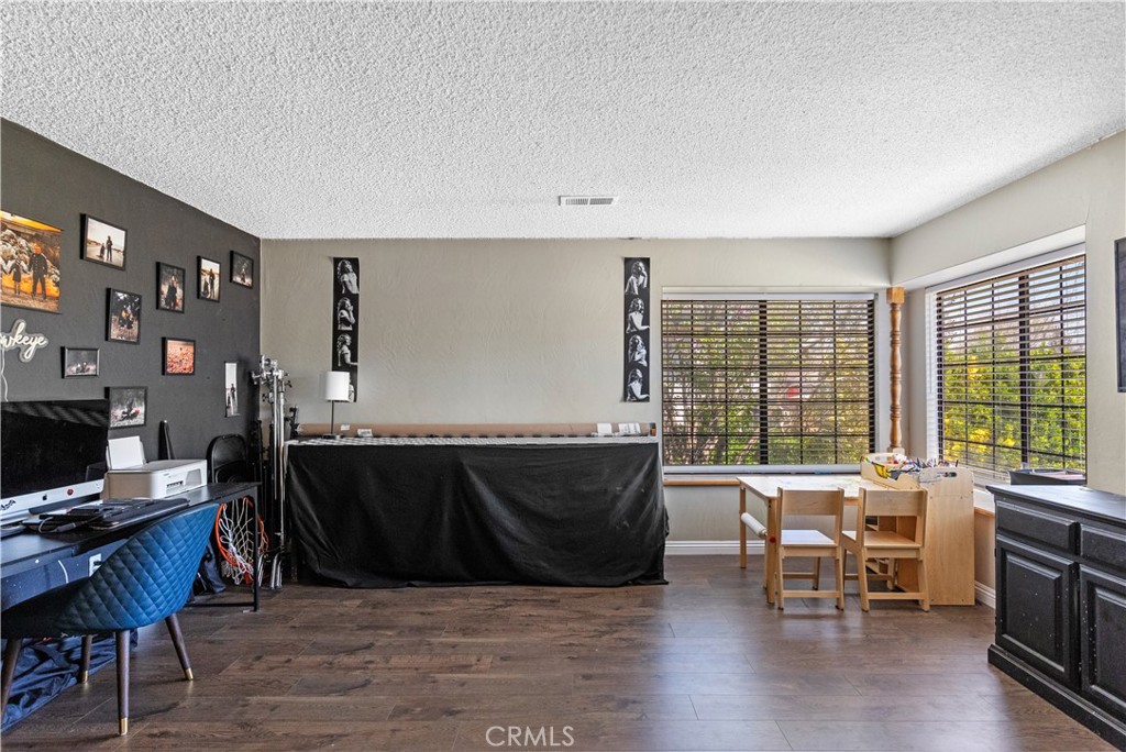21921 Fig Court Tehachapi, CA 93561 - Photo 16 of 44 a living room with furniture a large window and a flat screen tv