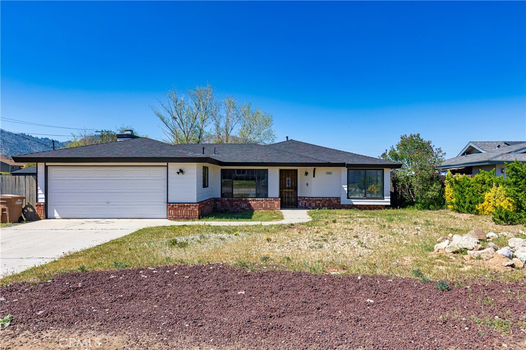 21921 Fig Court Tehachapi, CA 93561 - Photo 2 of 44 a front view of a house with a yard and garage