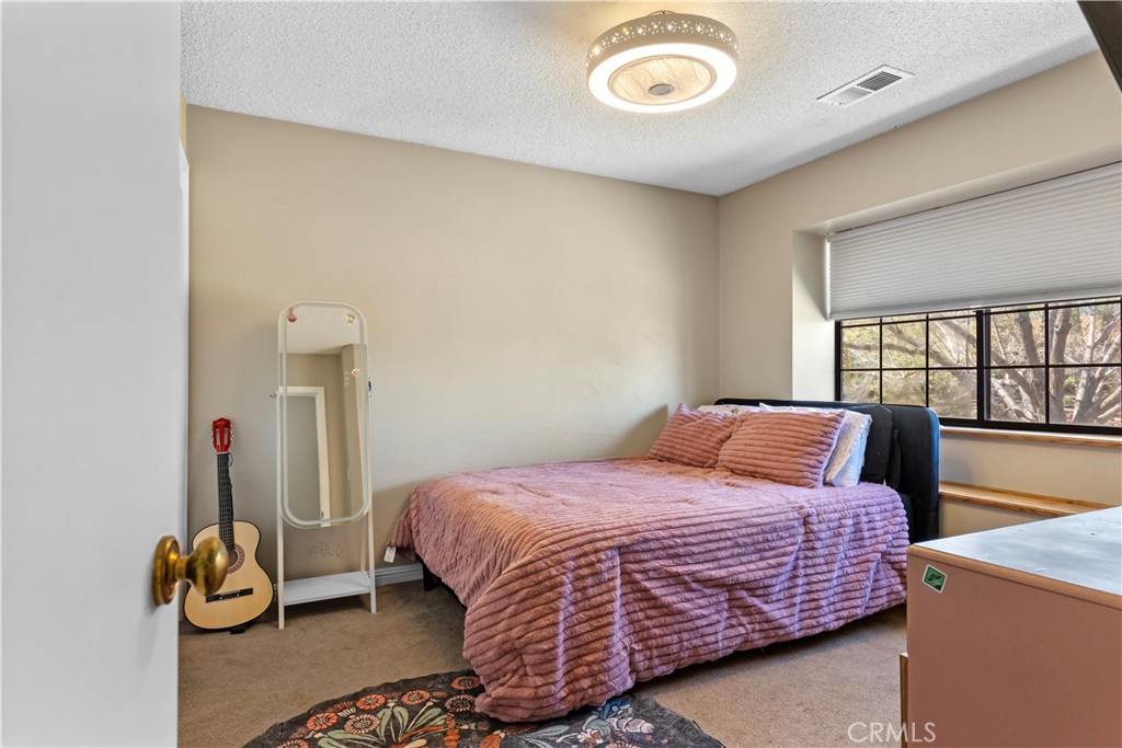 21921 Fig Court Tehachapi, CA 93561 - Photo 24 of 44 a bedroom with a bed and two window