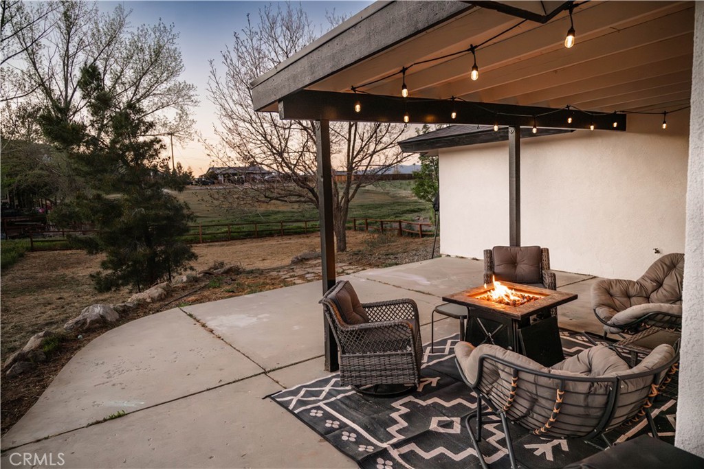 21921 Fig Court Tehachapi, CA 93561 - Photo 34 of 44 a view of a patio with table and chairs and potted plants