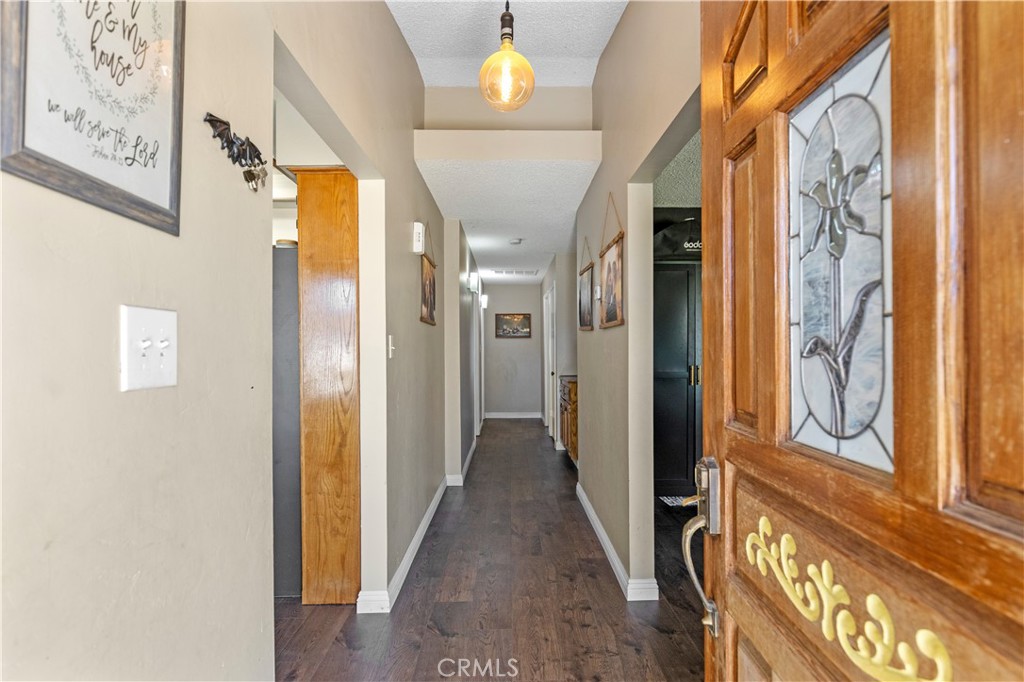 21921 Fig Court Tehachapi, CA 93561 - Photo 4 of 44 a view of hallway with wooden floor and door