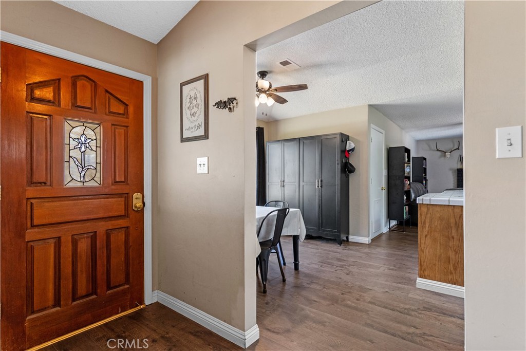 21921 Fig Court Tehachapi, CA 93561 - Photo 5 of 44 a view of a hallway to a livingroom with furniture and windows