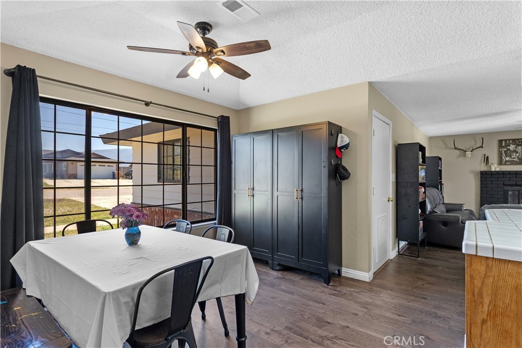 21921 Fig Court Tehachapi, CA 93561 - Photo 6 of 44 a view of a dining room with furniture window and wooden floor