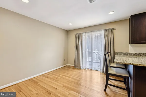 a view of kitchen with stainless steel appliances kitchen island granite countertop a refrigerator stove top oven and sink