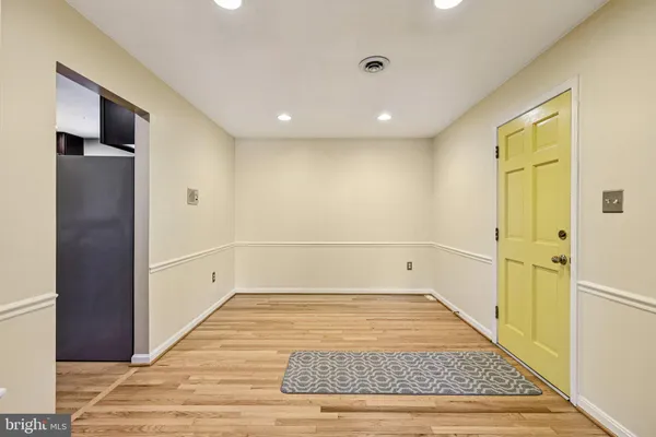 a view of a hallway with wooden floor