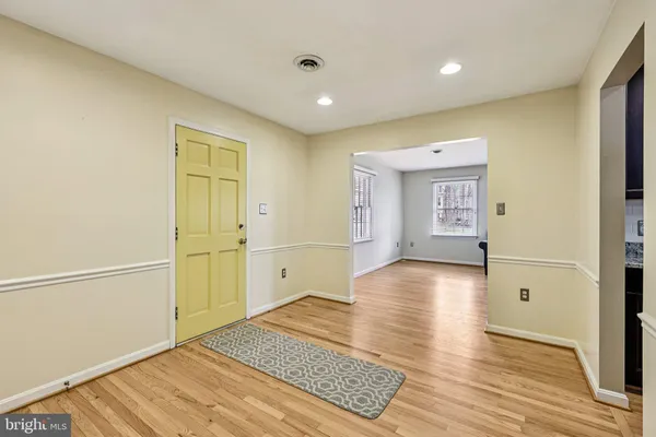 a view of hallway with wooden floor