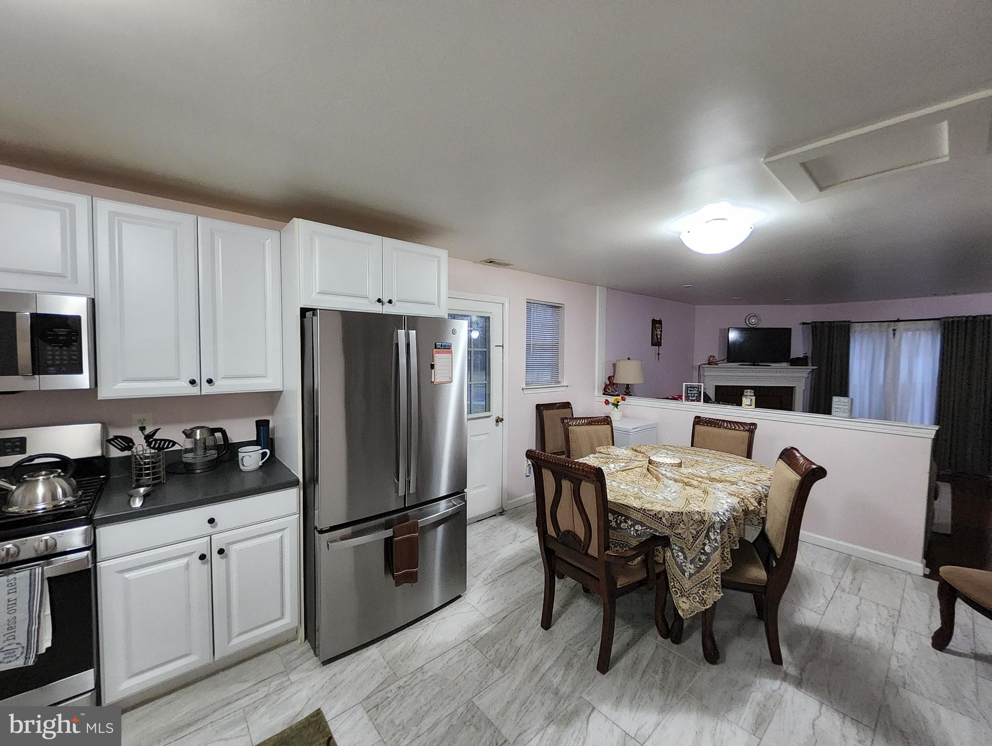 2 Adam Court Eastampton, NJ 08060 - Photo 13 of 34 a kitchen with stainless steel appliances a refrigerator a stove a dining table and chairs