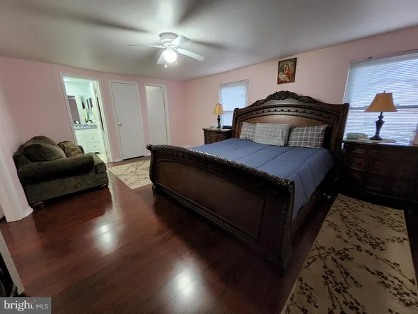 a bedroom with a bed and a couch