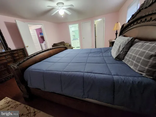 a bedroom with a bed and a mirror