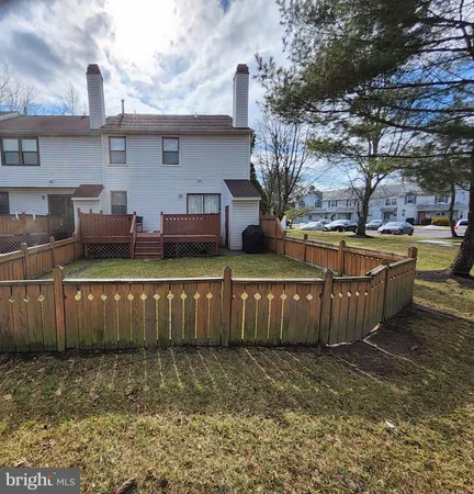 a view of a backyard with a large tree