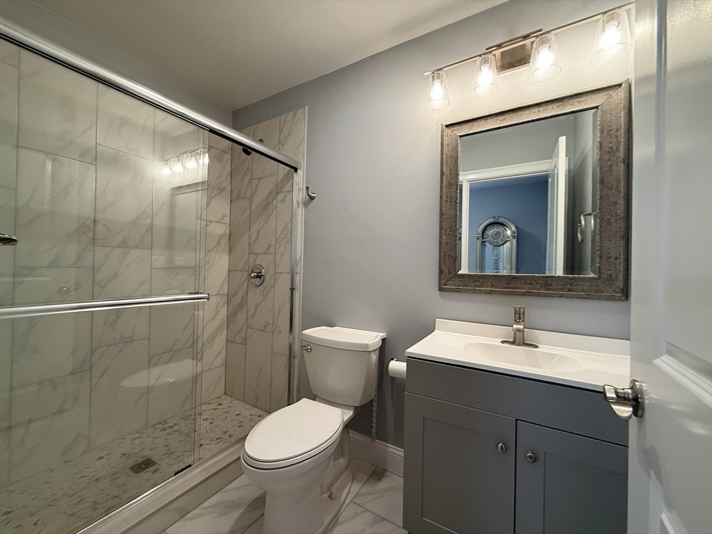 7 Waumbeck Street, Unit 3 Boston, MA 02121 - Photo 12 of 21 a bathroom with a sink a toilet and shower