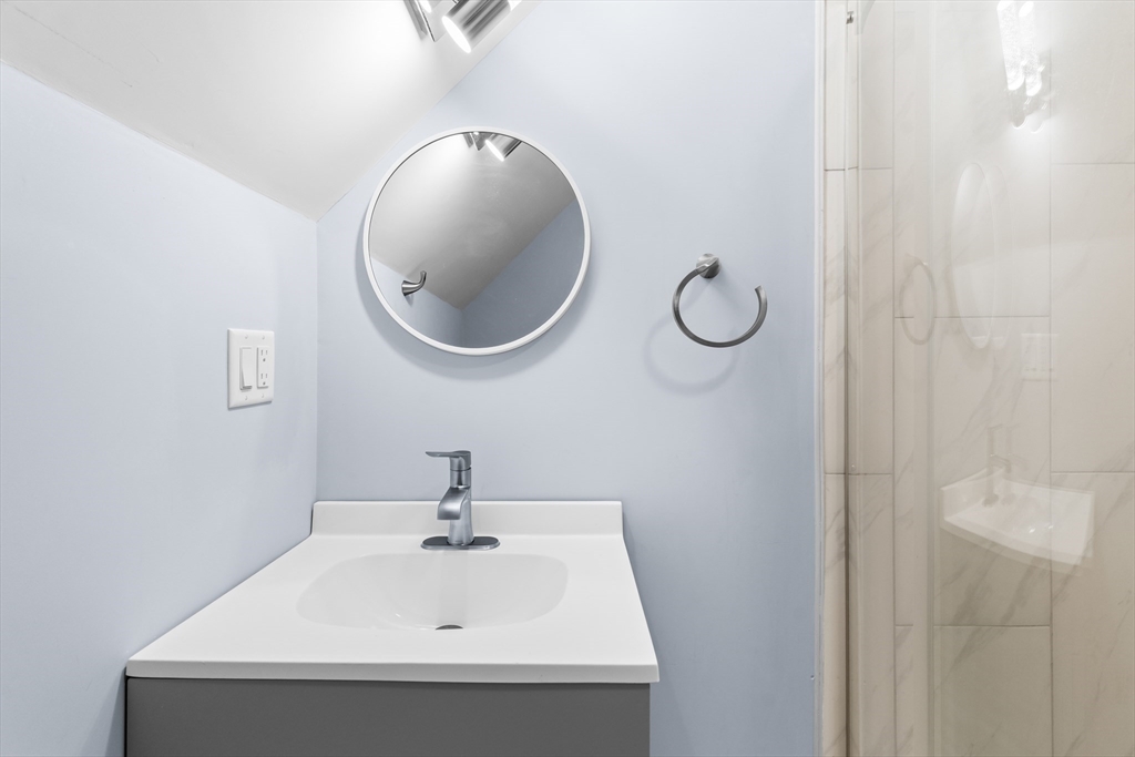 7 Waumbeck Street, Unit 3 Boston, MA 02121 - Photo 15 of 21 a bathroom with a sink and mirror