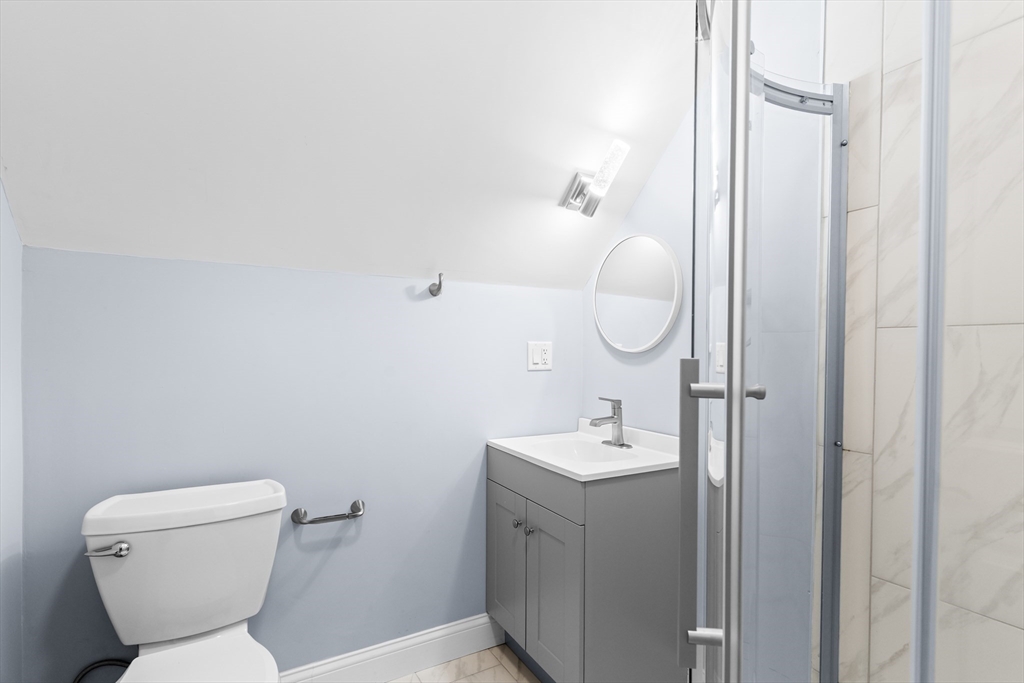 7 Waumbeck Street, Unit 3 Boston, MA 02121 - Photo 16 of 21 a bathroom with a toilet sink and mirror