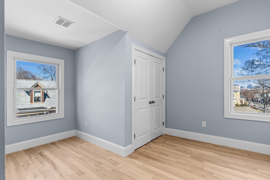 7 Waumbeck Street, Unit 3 Boston, MA 02121 - Photo 17 of 21 a view of an empty room with window and wooden floor