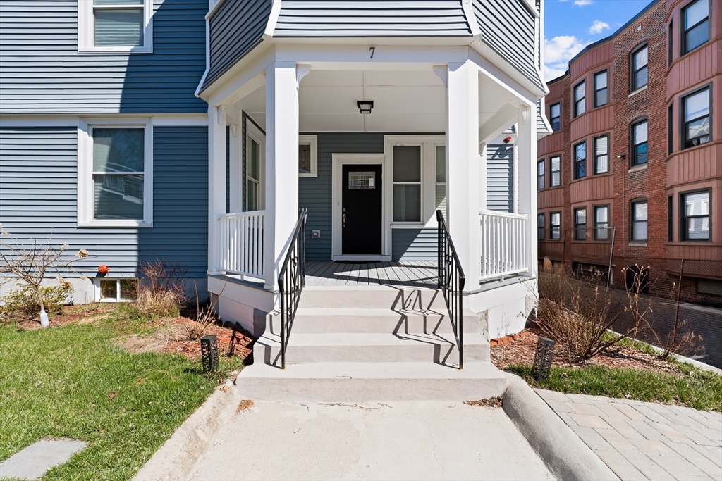 7 Waumbeck Street, Unit 3 Boston, MA 02121 - Photo 3 of 21 a front view of a house with a garden and plants