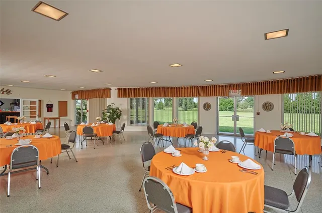 a living room with stainless steel appliances wooden floor and large window