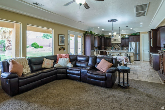 3683 South 2640 West St. George, UT 84790 - Photo 21 of 41 Open-concept living area featuring a kitchen with dark wood cabinetry and a central island