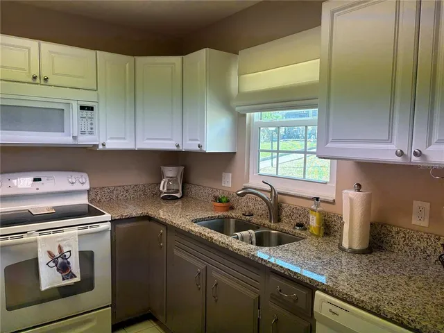 a kitchen with sink cabinets and window