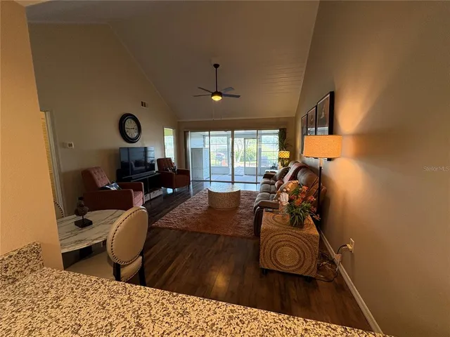 a living room with furniture a window and a chandelier