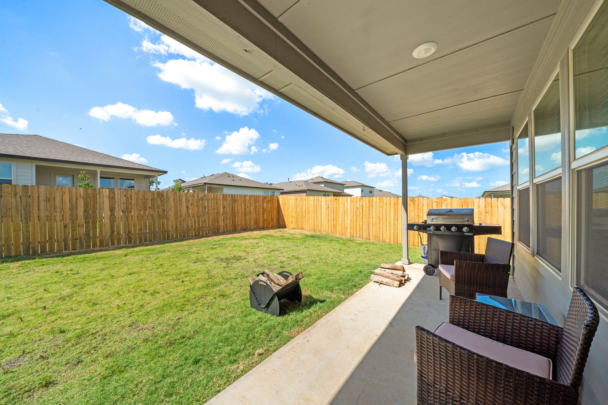1117 Tipton Street Georgetown, TX 78633 - Photo 36 of 40 Expansive backyard featuring a covered patio, concrete slab, and wood privacy fencing