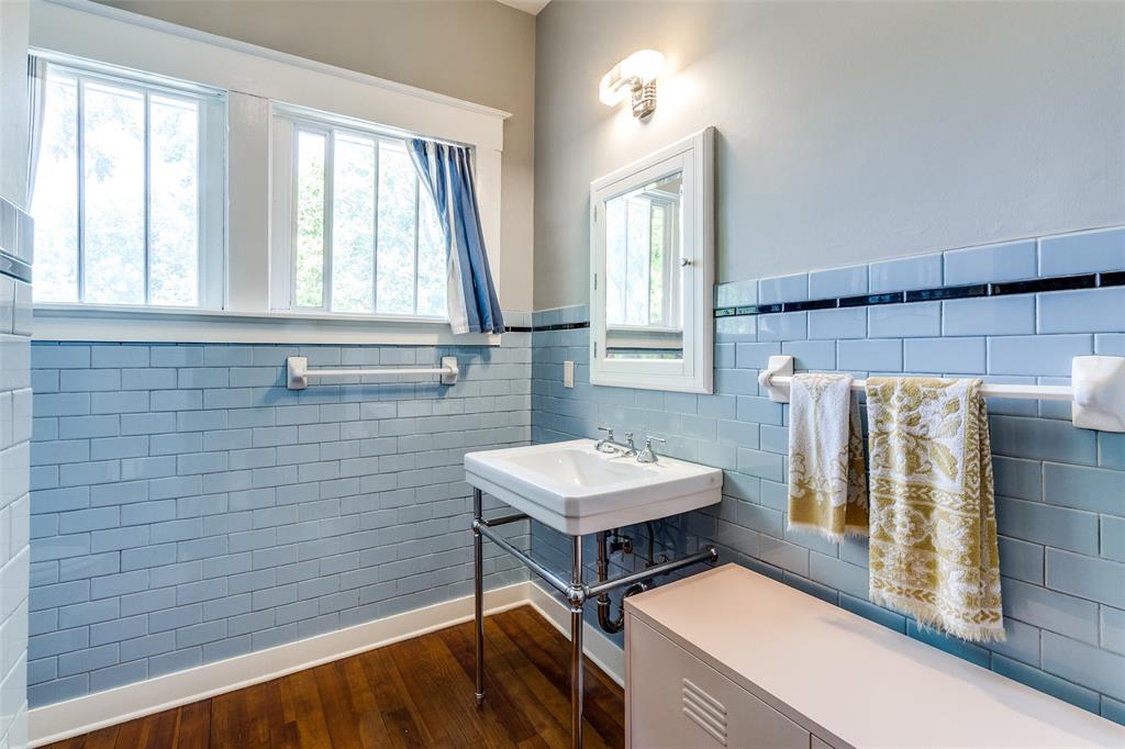 5020 Junius Street Dallas, TX 75214 - Photo 23 of 31 a bathroom with a sink a mirror and a bathtub