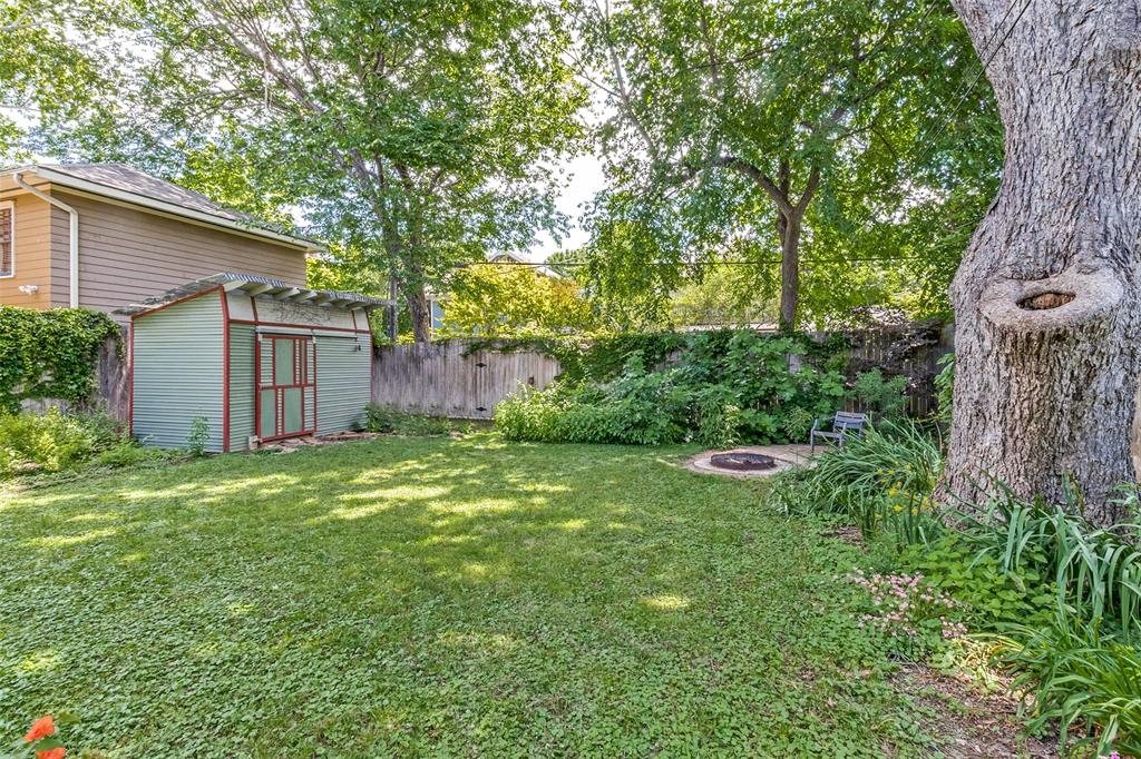 5020 Junius Street Dallas, TX 75214 - Photo 27 of 31 a backyard of a house with plants and large tree