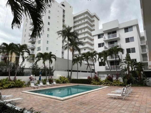 1665 Bay Road, Unit 316 Miami Beach, FL 33139 - Photo 1 of 12 a front view of multi story residential apartment building with yard and sign board