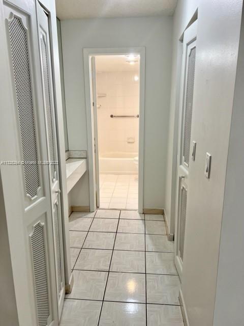 1665 Bay Road, Unit 316 Miami Beach, FL 33139 - Photo 6 of 12 a bathroom with a glass door shower and a sink