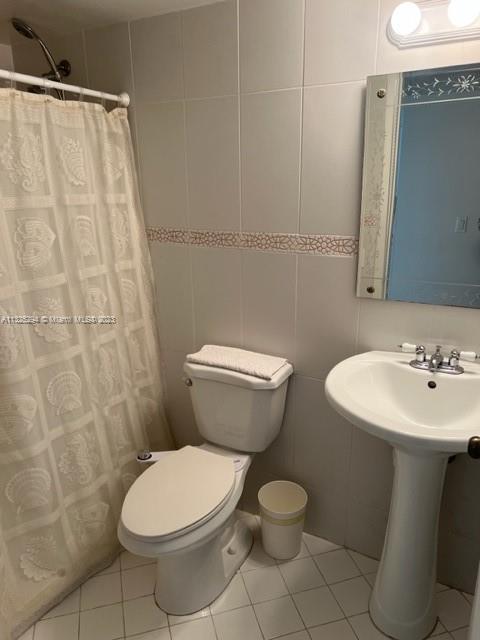 1665 Bay Road, Unit 316 Miami Beach, FL 33139 - Photo 8 of 12 a bathroom with a toilet sink and mirror