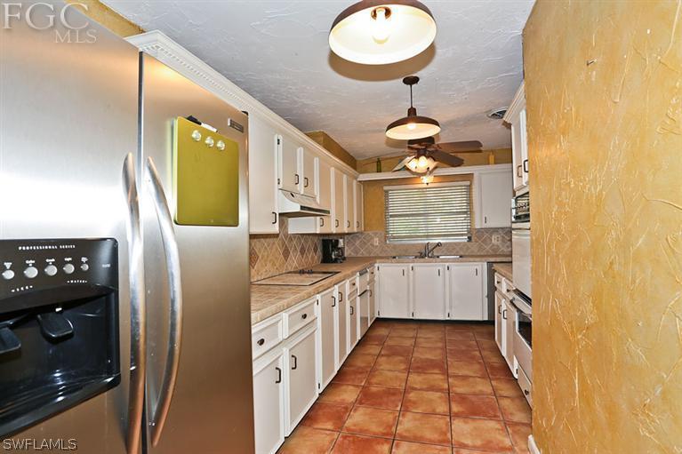 1806 Ardmore Road Fort Myers, FL 33901 - Photo 9 of 11 a kitchen with stainless steel appliances granite countertop a sink and cabinets