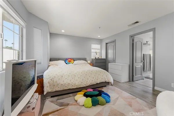 a bedroom with a bed and a dresser