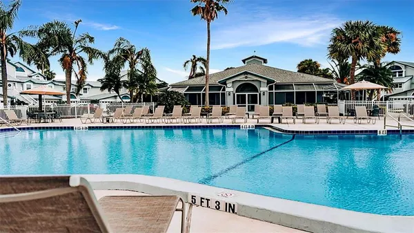 a view of swimming pool with outdoor seating and lake view